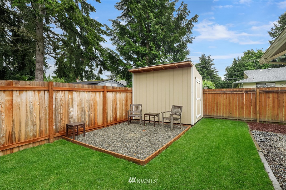 4010 Northeast 19th Street Renton, WA 98056 - Photo 23 of 25 a view of a backyard with table and chairs and a large tree