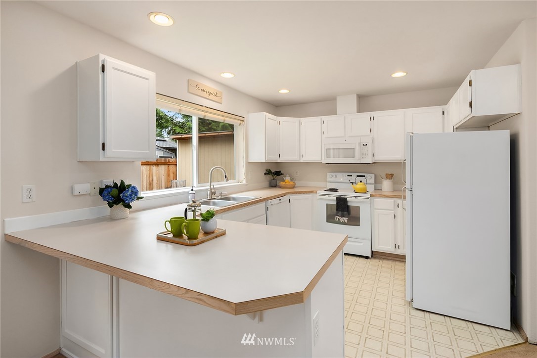 4010 Northeast 19th Street Renton, WA 98056 - Photo 8 of 25 a kitchen with white cabinets and white appliances