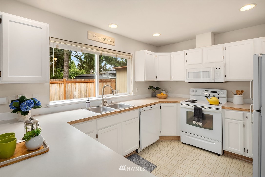 4010 Northeast 19th Street Renton, WA 98056 - Photo 9 of 25 a kitchen that has a sink and a stove in it