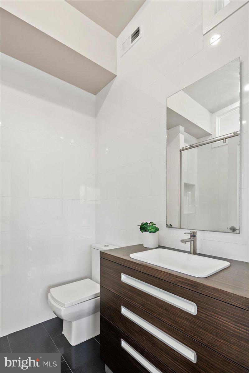 4324 Rosedale Avenue Bethesda, MD 20814 - Photo 49 of 73 Sleek modern bathroom with elegance.