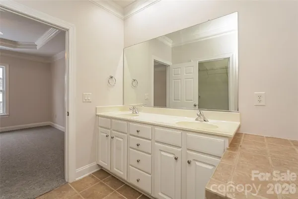 a bathroom with a double vanity sink and mirror