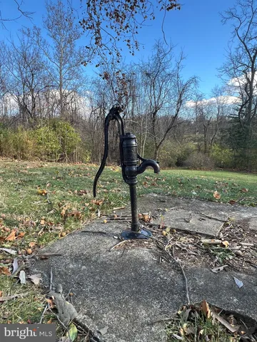 a large house with a big yard and large trees