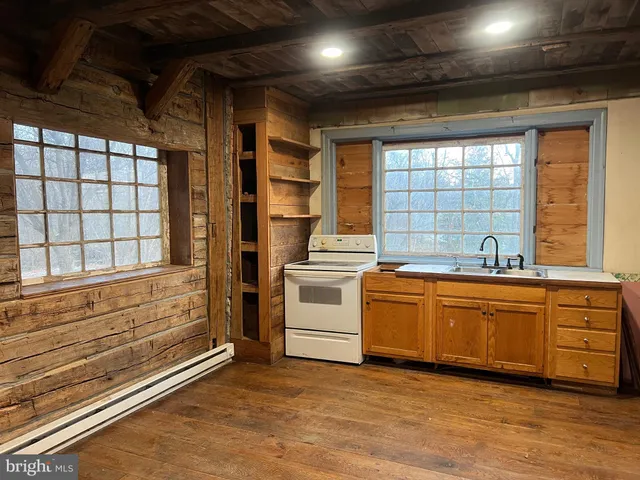 a kitchen with sink window and stainless steel appliances