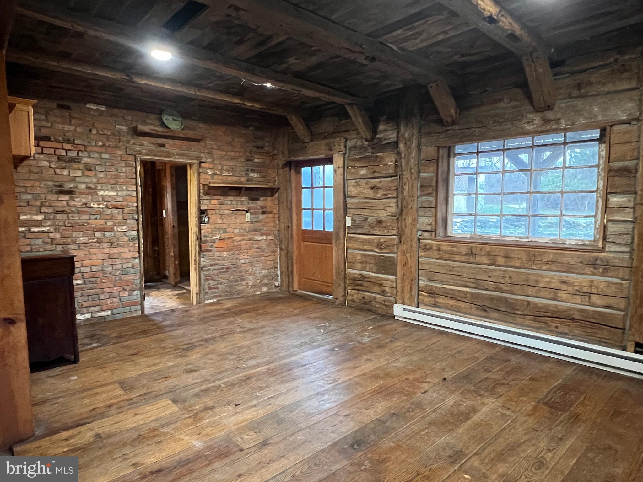 40 North Fileys Road Dillsburg, PA 17019 - Photo 7 of 25 an empty room with wooden floor and windows