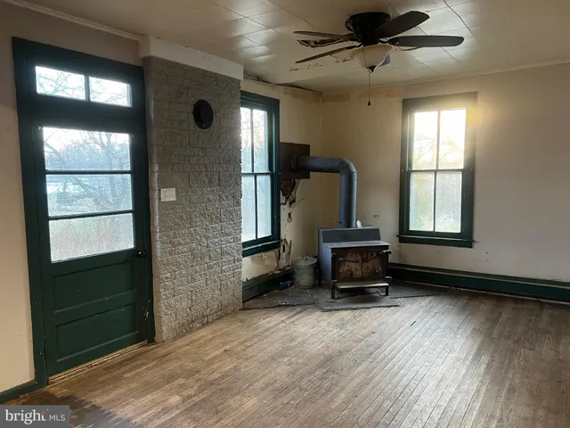 a living room with a bed furniture and a window