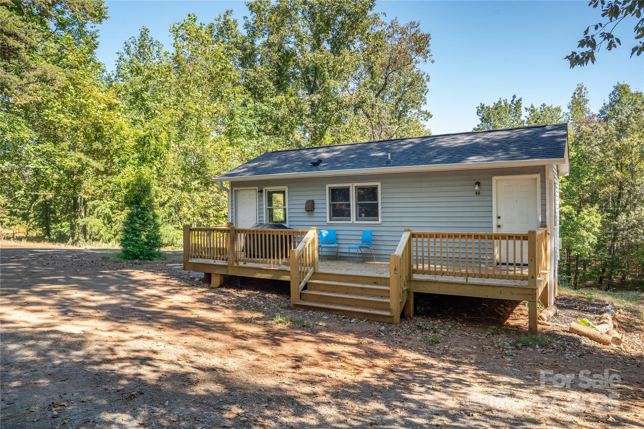 a view of a house with a yard and sitting area