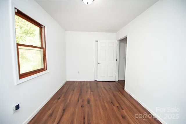 a view of workspace with wooden floor and windows