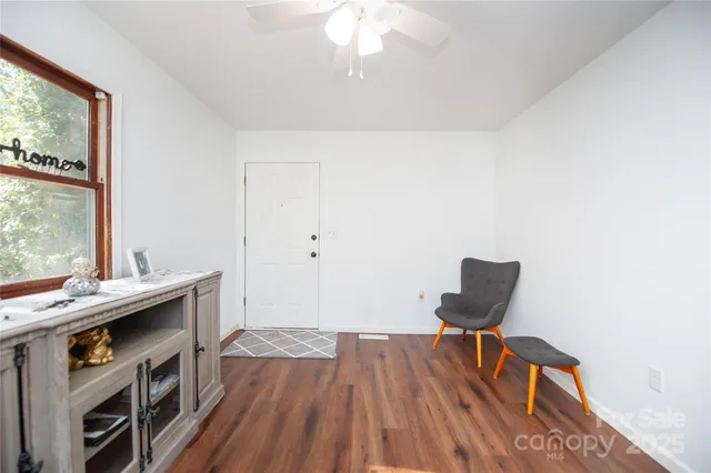 a view of workspace with wooden floor and furniture