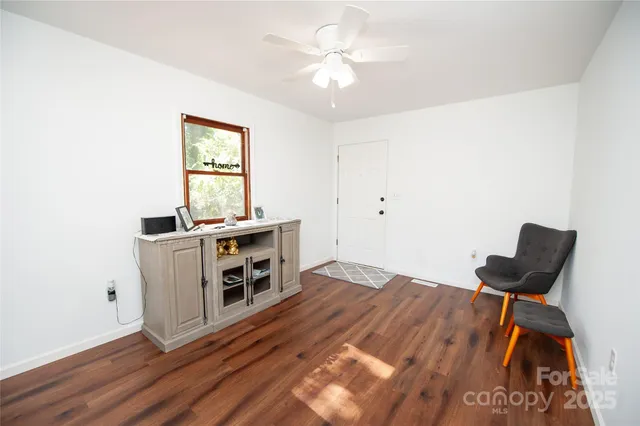 a view of workspace with furniture and wooden floor
