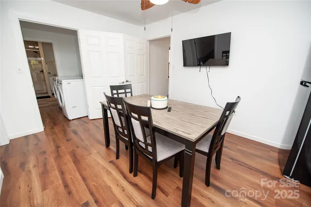 a view of a dining room with furniture and wooden floor