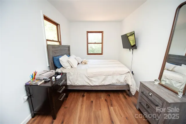 a bed sitting in a bedroom next to a window