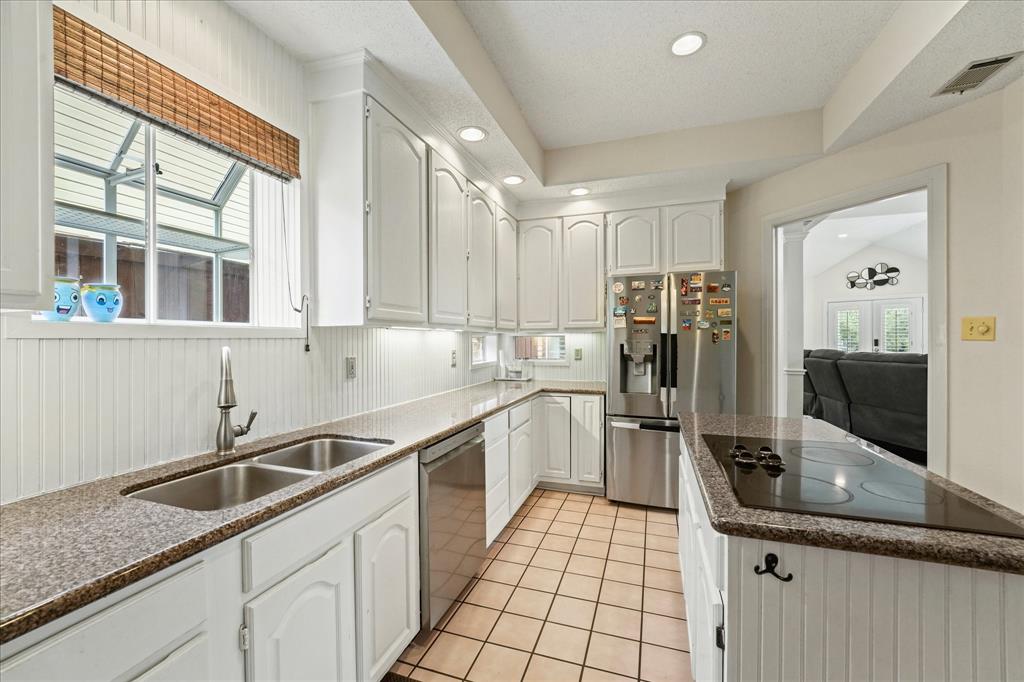 9420 Blue Jay Way Irving, TX 75063 - Photo 13 of 27 a kitchen with a sink and stainless steel appliances
