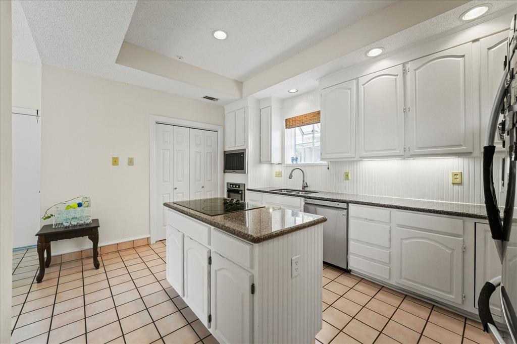 9420 Blue Jay Way Irving, TX 75063 - Photo 14 of 27 a kitchen with a sink appliances and cabinets