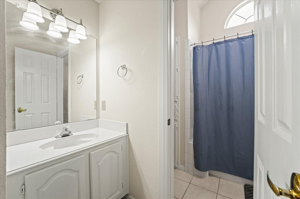 9420 Blue Jay Way Irving, TX 75063 - Photo 18 of 27 a bathroom with a sink and a mirror