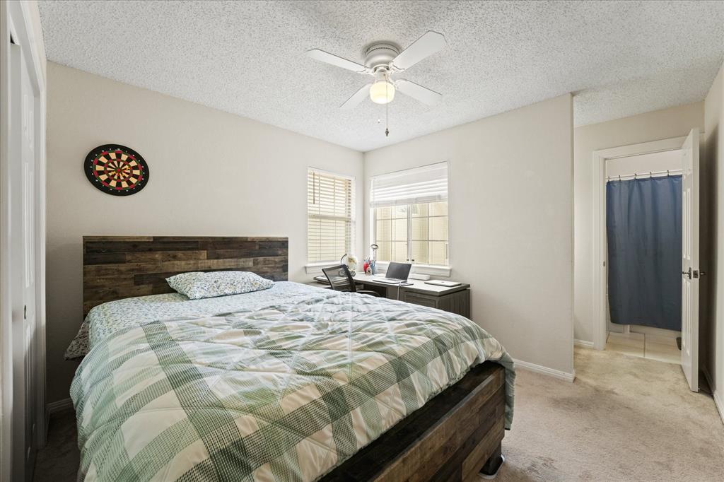 9420 Blue Jay Way Irving, TX 75063 - Photo 19 of 27 a bedroom with a bed and a chandelier