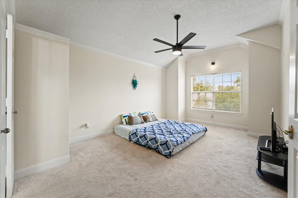 9420 Blue Jay Way Irving, TX 75063 - Photo 20 of 27 a bedroom with a bed and a chandelier