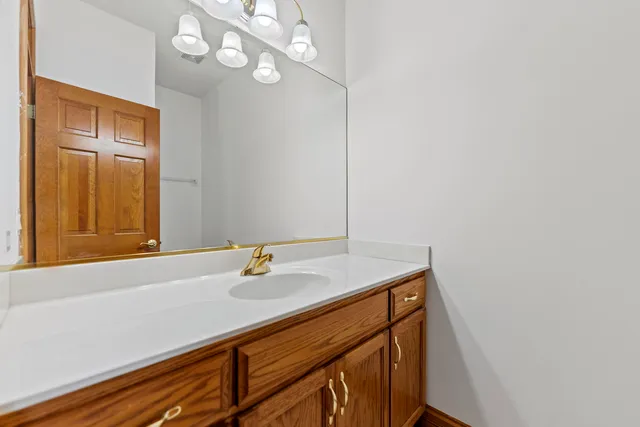 a bathroom with a sink a vanity and a mirror