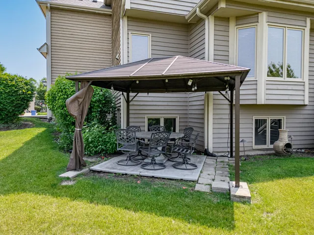 a front view of a house with a garden and patio
