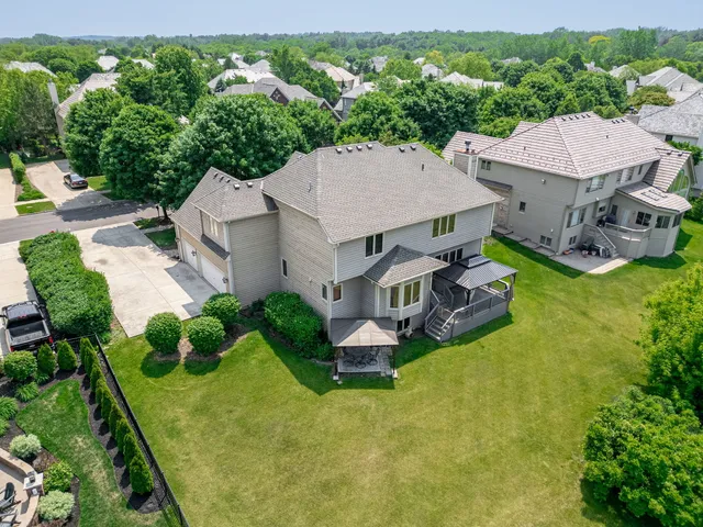 an aerial view of a house with swimming pool and garden view