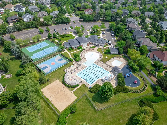 an aerial view of a swimming pool patio fire pit and outdoor kitchen