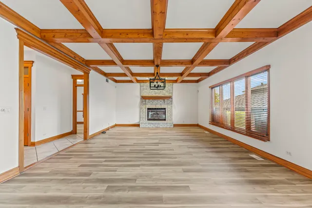 a big room with wooden floors and windows