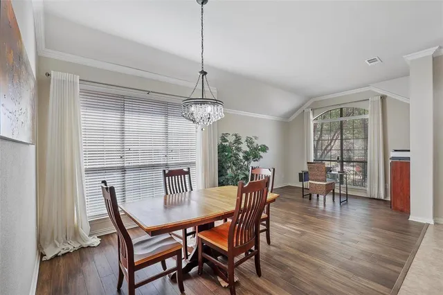 a view of a room with a table and chairs