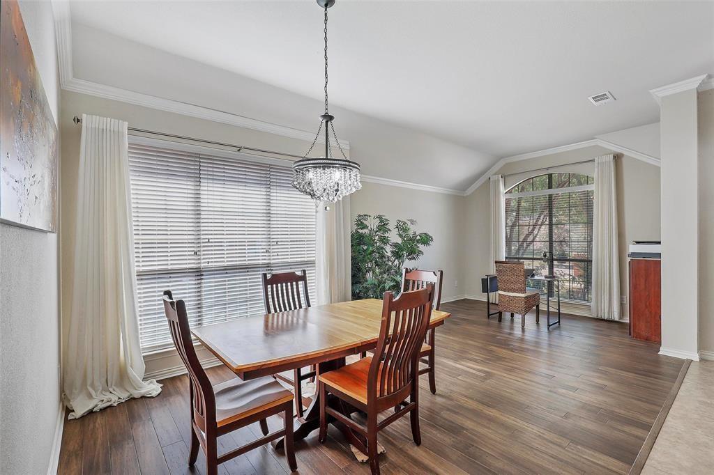 7067 Nantucket Way Grand Prairie, TX 75054 - Photo 16 of 40 a view of a dining room with furniture window and wooden floor
