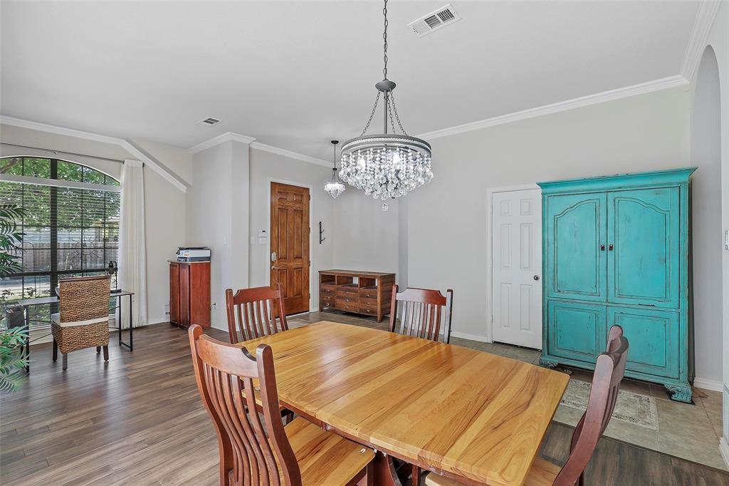 7067 Nantucket Way Grand Prairie, TX 75054 - Photo 20 of 40 a view of a dining room with furniture window and wooden floor
