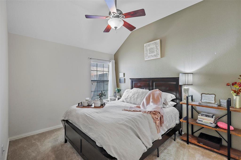 7067 Nantucket Way Grand Prairie, TX 75054 - Photo 22 of 40 a bedroom with a bed and a chandelier