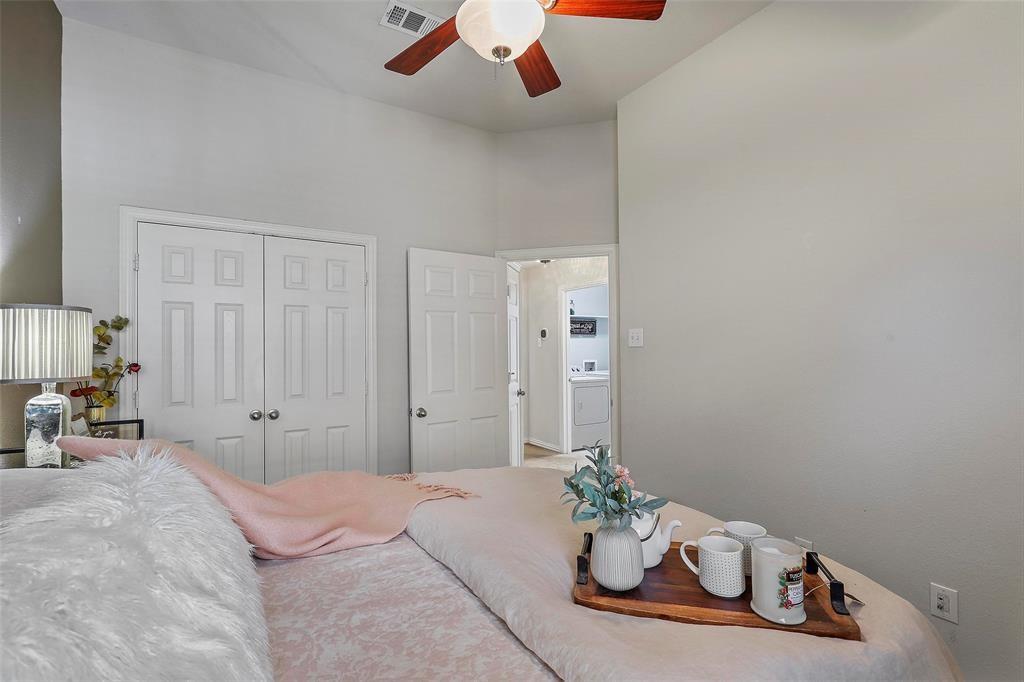 7067 Nantucket Way Grand Prairie, TX 75054 - Photo 23 of 40 a bedroom with furniture and a chandelier fan
