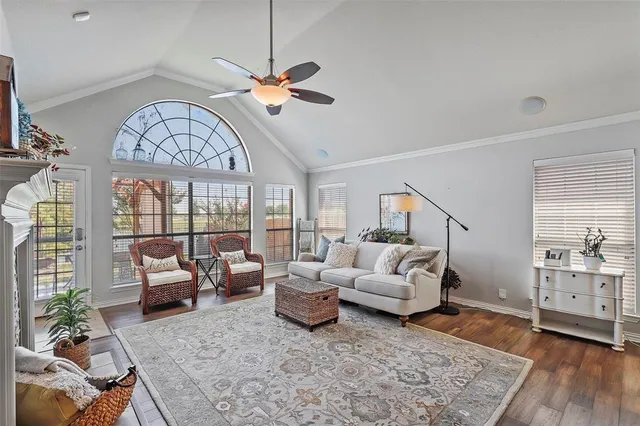a living room with furniture and large windows