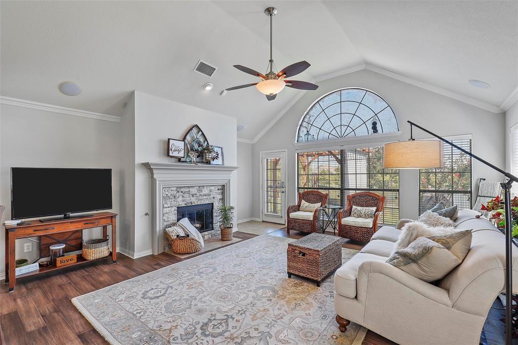 7067 Nantucket Way Grand Prairie, TX 75054 - Photo 10 of 40 a living room with furniture a fireplace and a flat screen tv
