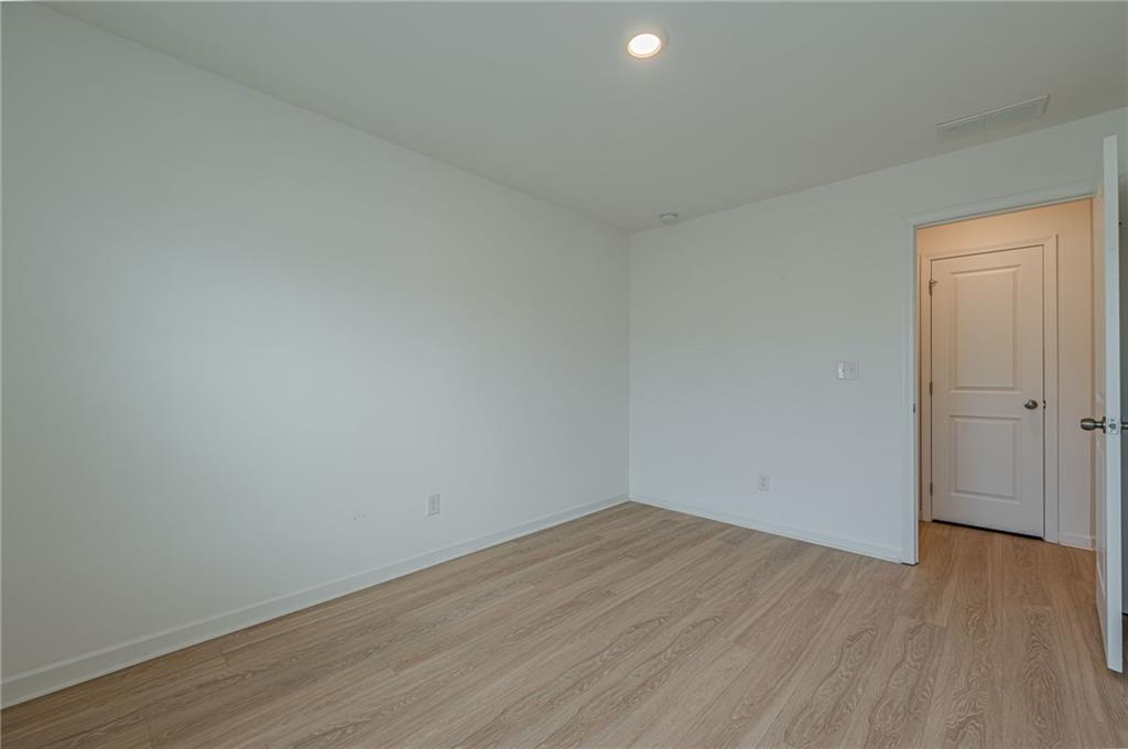 628 Isom Walk Suwanee, GA 30024 - Photo 26 of 39 a view of a room with wooden floor