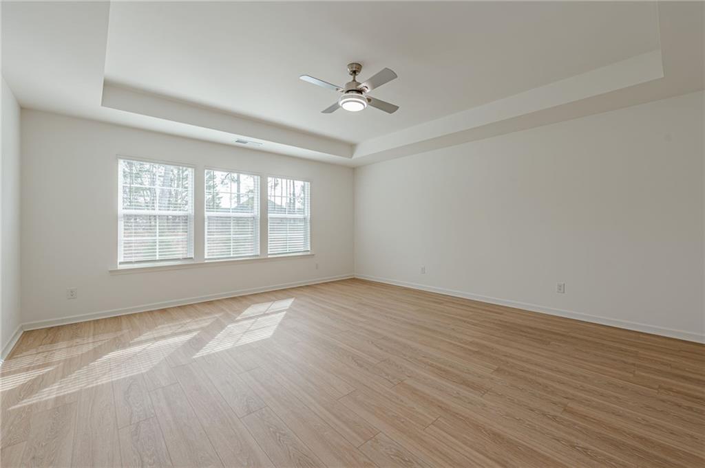 628 Isom Walk Suwanee, GA 30024 - Photo 27 of 39 wooden floor in an empty room with a window