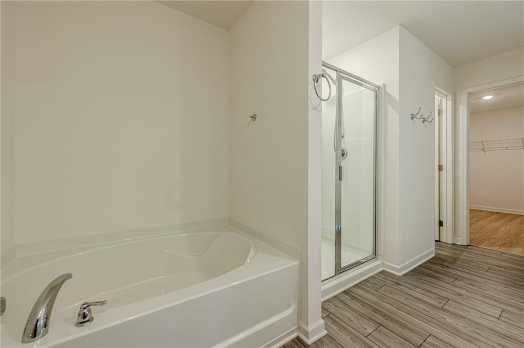 628 Isom Walk Suwanee, GA 30024 - Photo 31 of 39 a bathroom with a tub and shower