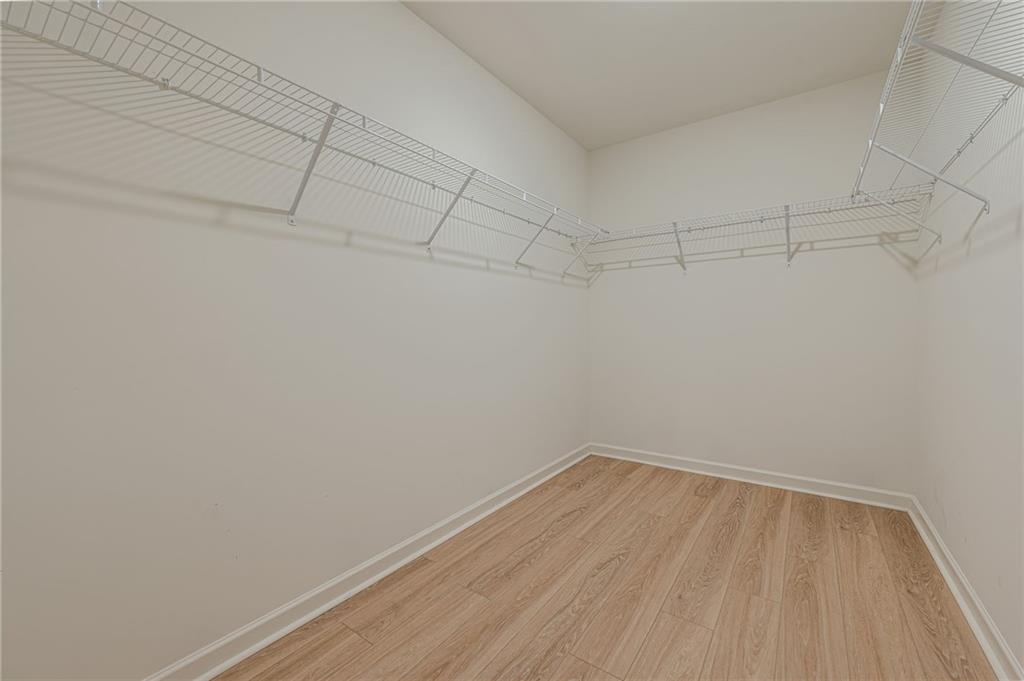 628 Isom Walk Suwanee, GA 30024 - Photo 33 of 39 a view of a room with racks on the wall