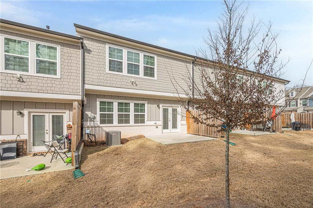 628 Isom Walk Suwanee, GA 30024 - Photo 37 of 39 a front view of a house with a yard and garage