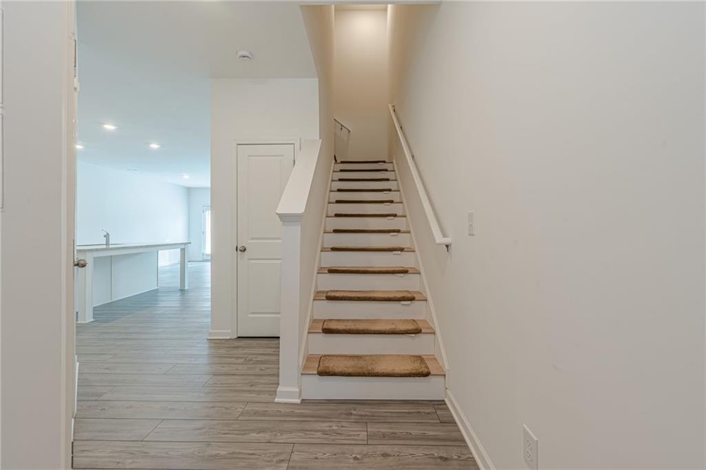 628 Isom Walk Suwanee, GA 30024 - Photo 5 of 39 a view of entryway and hall with wooden floor