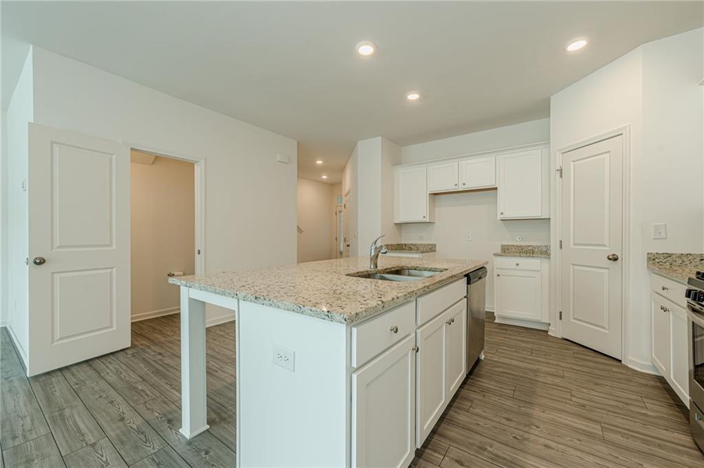 628 Isom Walk Suwanee, GA 30024 - Photo 9 of 39 a kitchen with a sink stove and cabinets