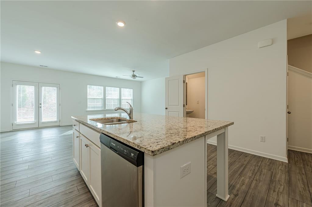 628 Isom Walk Suwanee, GA 30024 - Photo 10 of 39 a kitchen with a sink and wooden floor