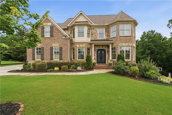 a front view of a house with a yard