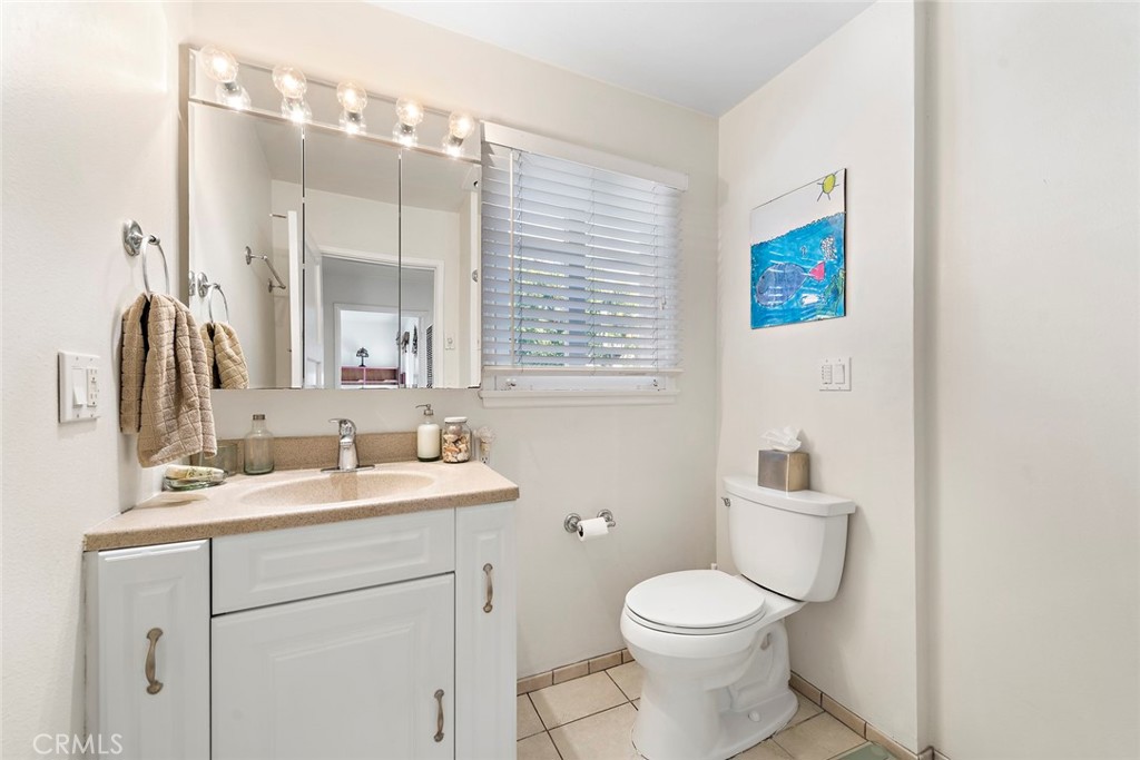 490 Shadow Lane Laguna Beach, CA 92651 - Photo 16 of 18 a bathroom with a toilet sink and mirror