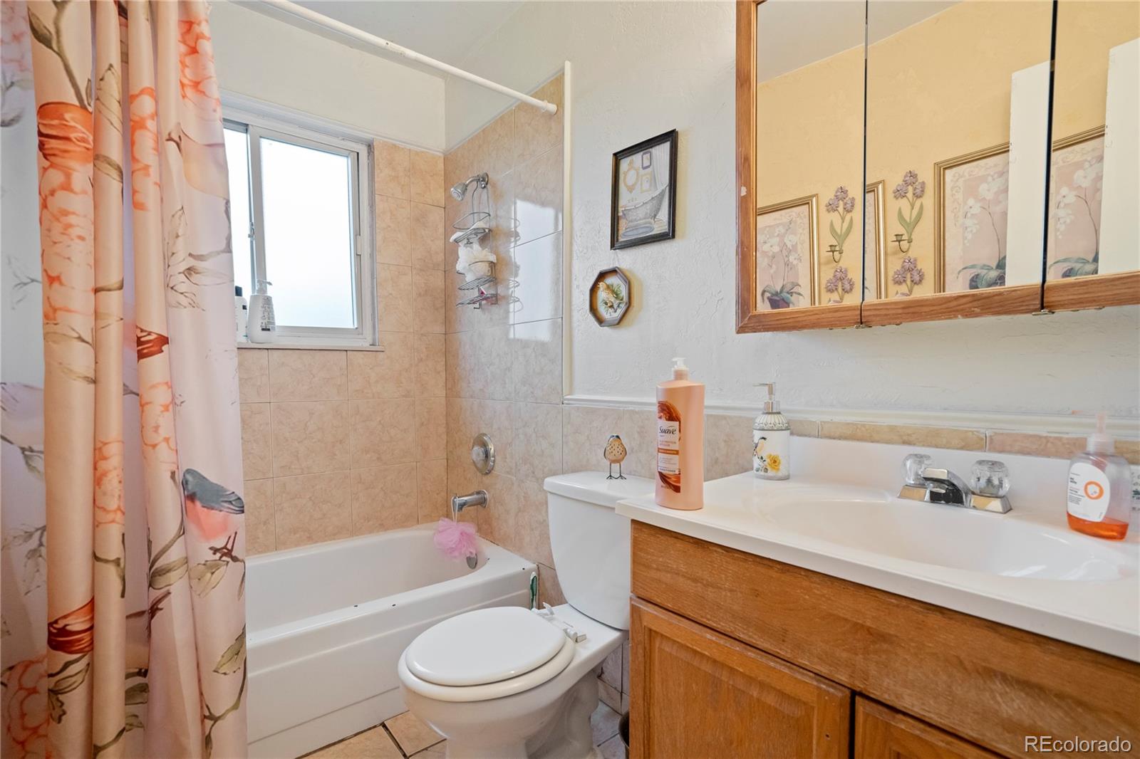 4345 South Chamberlin Colorado Springs Colorado Springs, CO 80906 - Photo 12 of 23 a bathroom with a sink a toilet and a bathtub