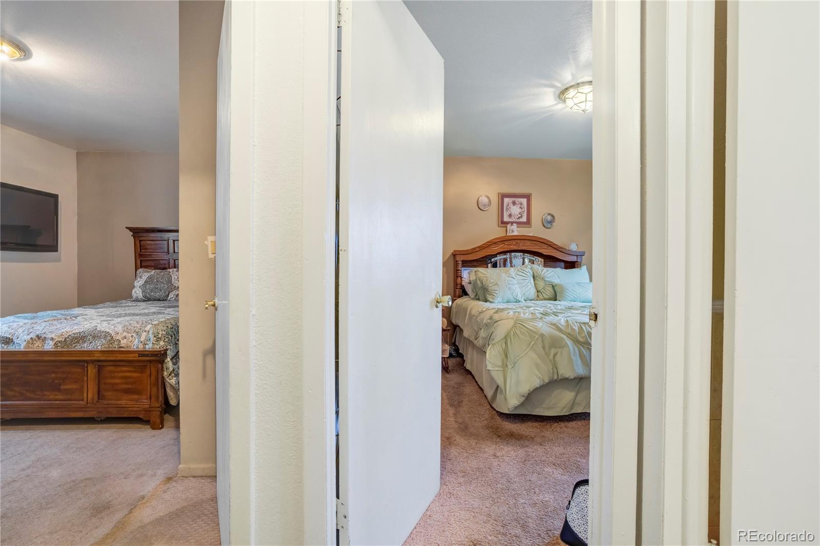 4345 South Chamberlin Colorado Springs Colorado Springs, CO 80906 - Photo 13 of 23 a bedroom with a bed and a mirror