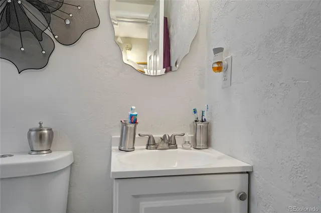 a bedroom with a bed and painting on the wall