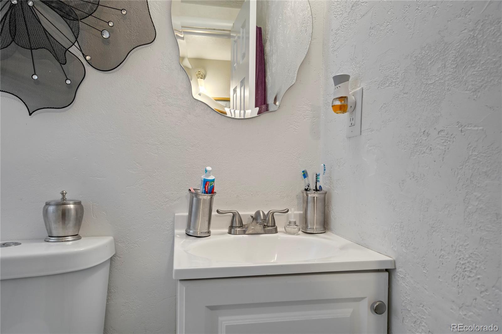 4345 South Chamberlin Colorado Springs Colorado Springs, CO 80906 - Photo 19 of 23 a bathroom with a sink and a mirror