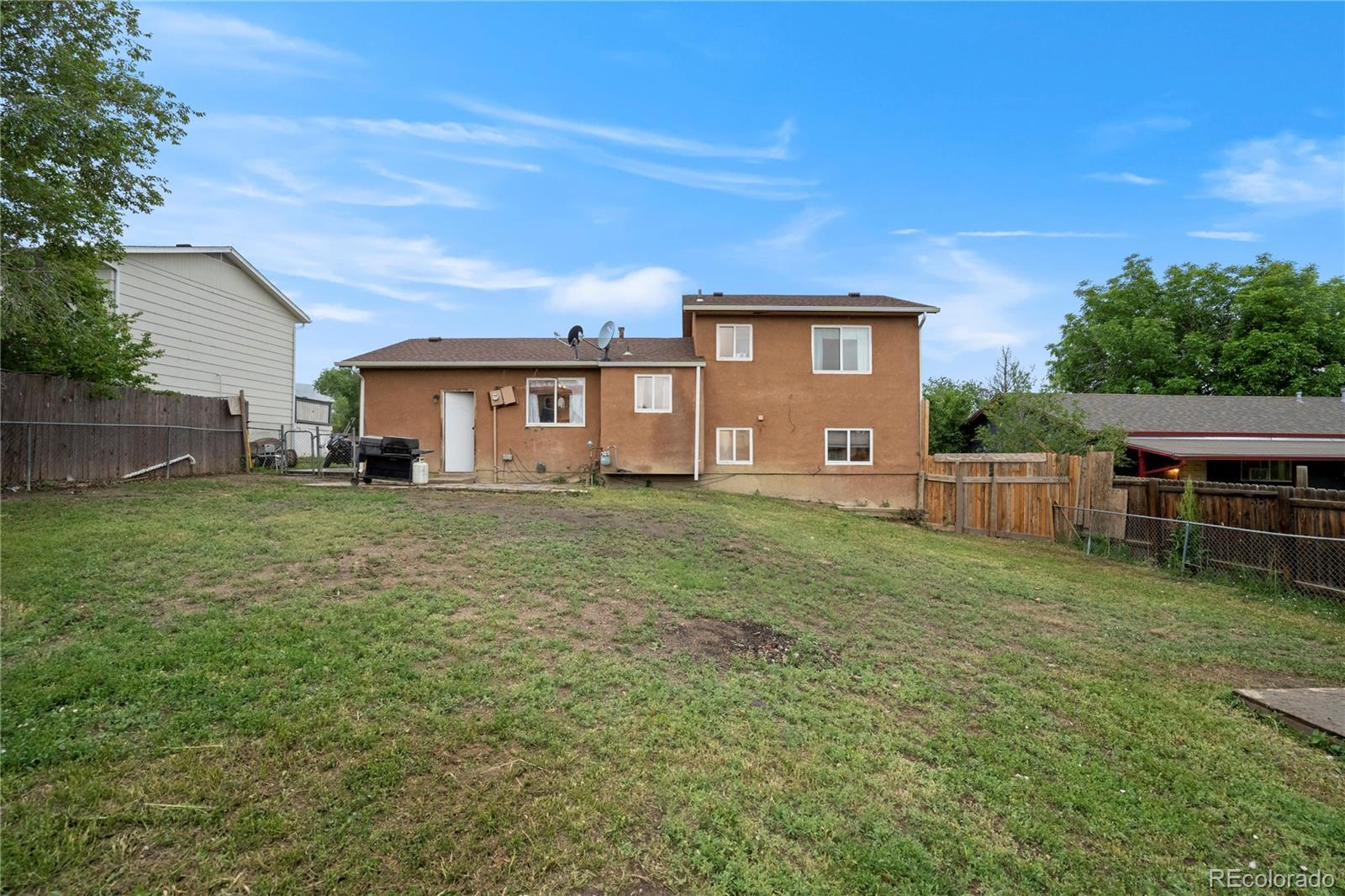 4345 South Chamberlin Colorado Springs Colorado Springs, CO 80906 - Photo 22 of 23 a view of a house with a yard