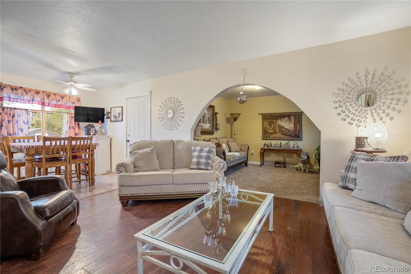 4345 South Chamberlin Colorado Springs Colorado Springs, CO 80906 - Photo 3 of 23 a living room with furniture and a wooden floor