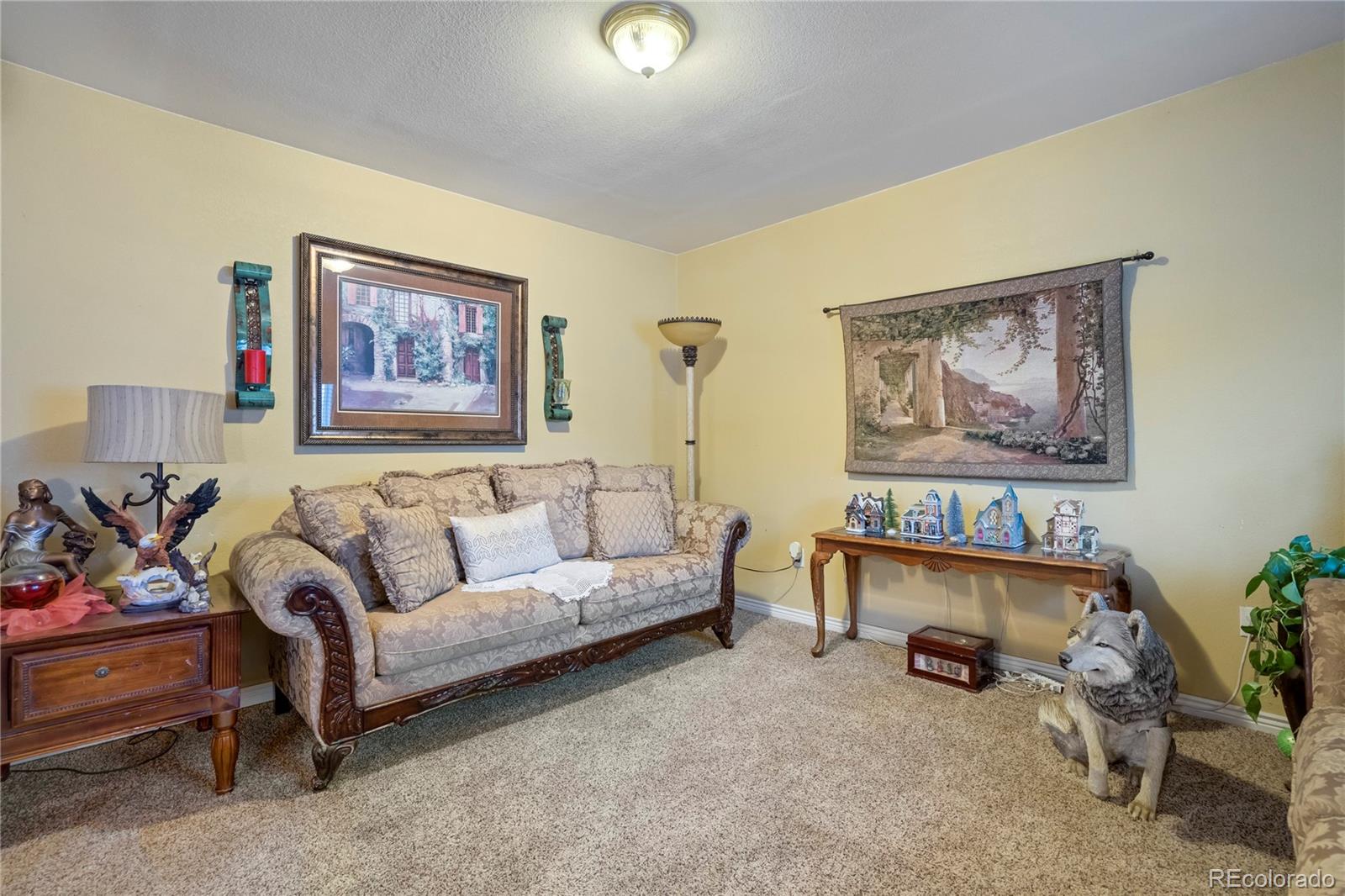 4345 South Chamberlin Colorado Springs Colorado Springs, CO 80906 - Photo 7 of 23 a living room with furniture and a baby crib