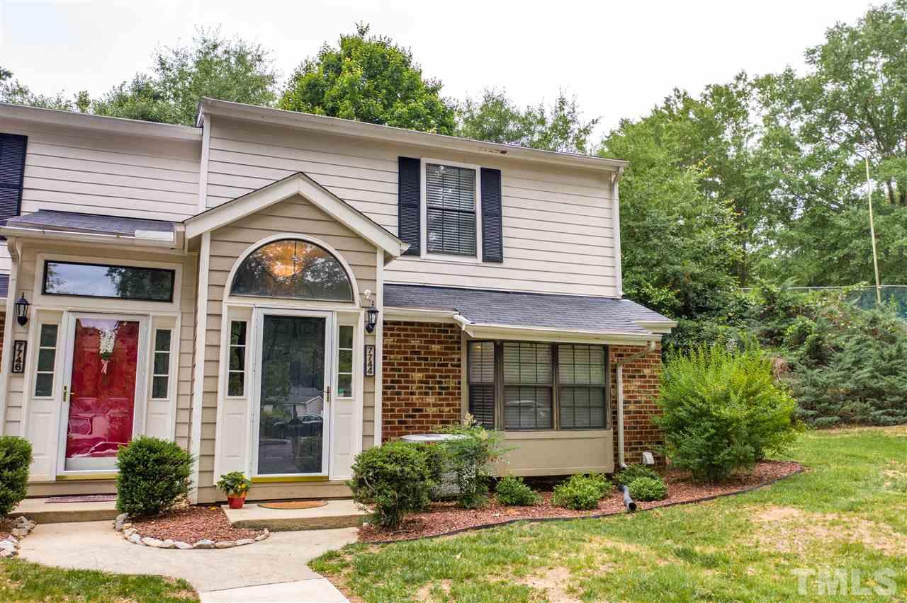 7744 Falcon Rest Circle Raleigh, NC 27615 - Photo 1 of 22 a front view of a house with garden